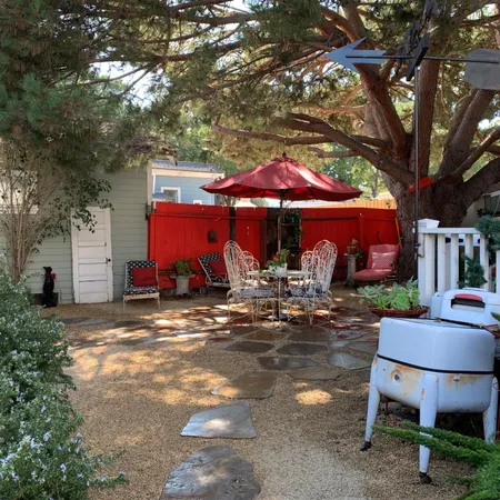 a view of a house with yard and sitting area