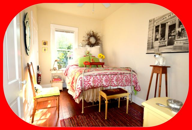 a bed room with a bed chair and a lamp