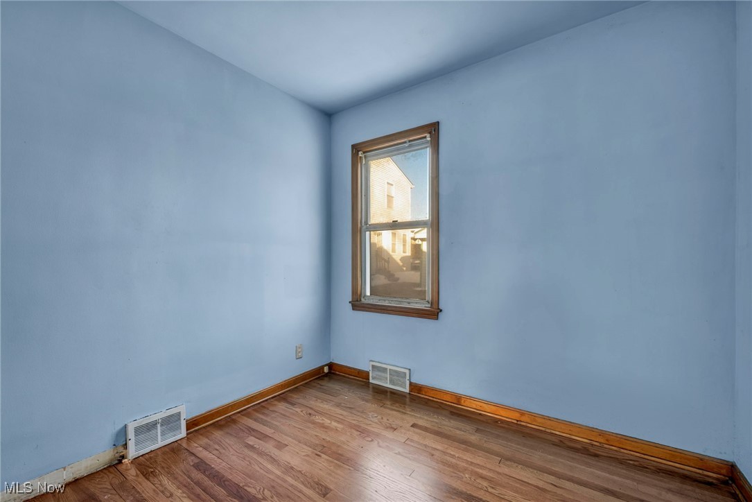 14750 Schreiber Road Maple Heights, OH 44137 - Photo 21 of 44 Unfurnished room featuring hardwood / wood-style floors and baseboards