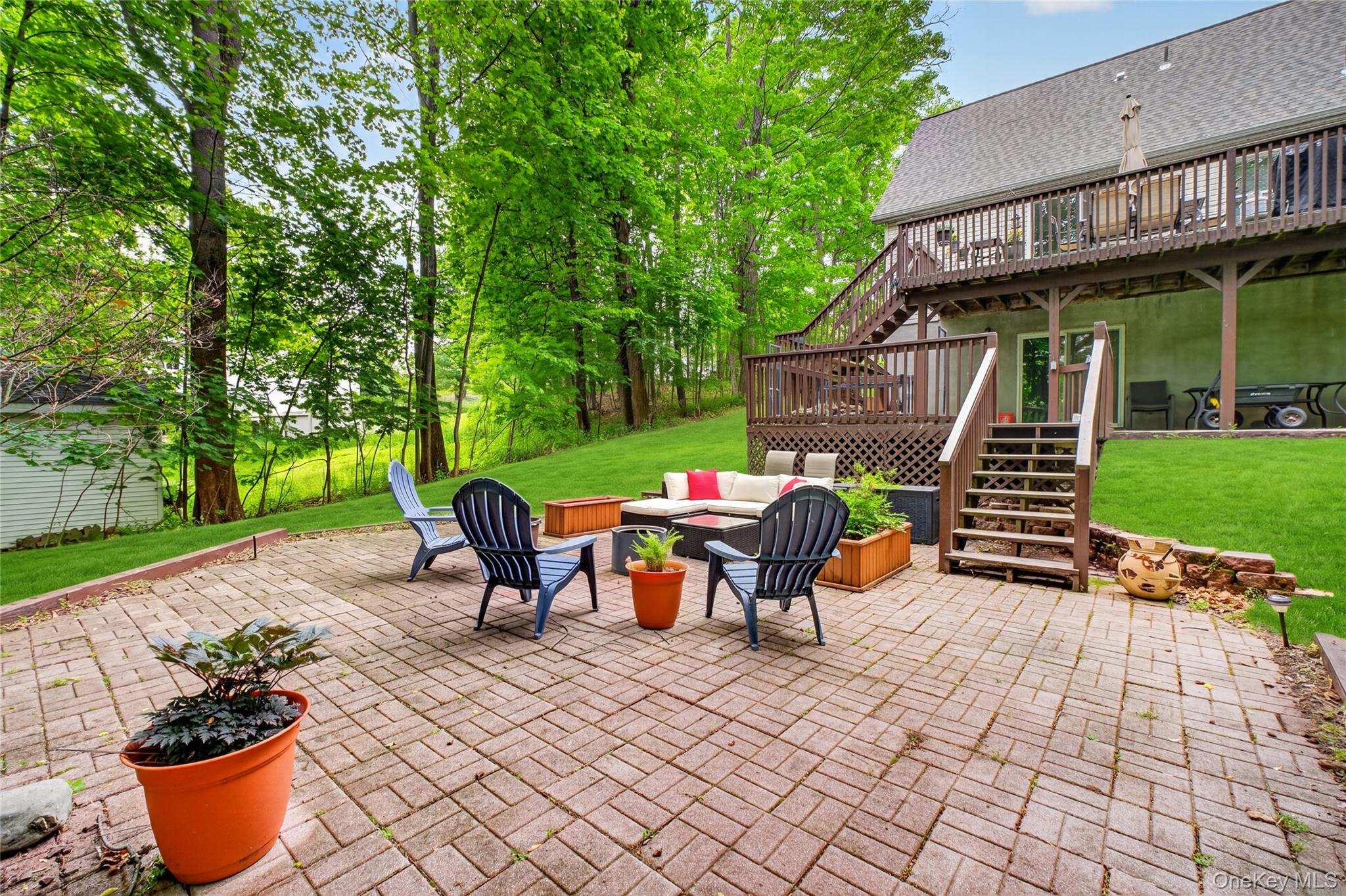 127 Belvedere Road Beacon, NY 12508 - Photo 26 of 37 a view of a patio with table and chairs potted plants and large tree