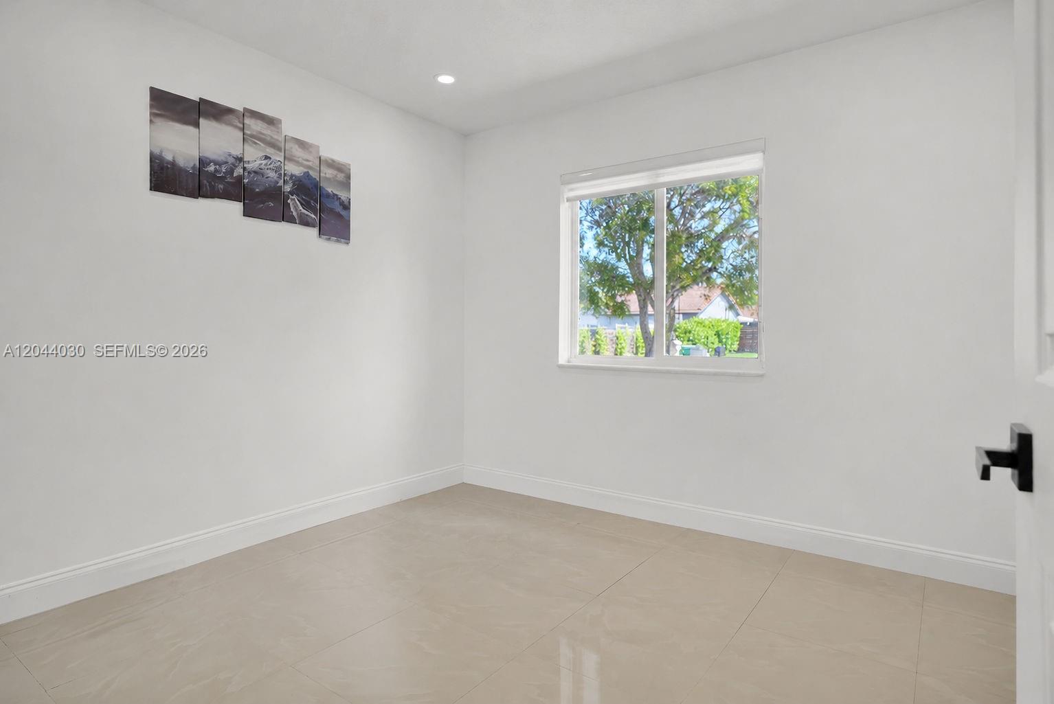 12551 Southwest 223rd Street Miami, FL 33170 - Photo 12 of 35 an empty room with a window