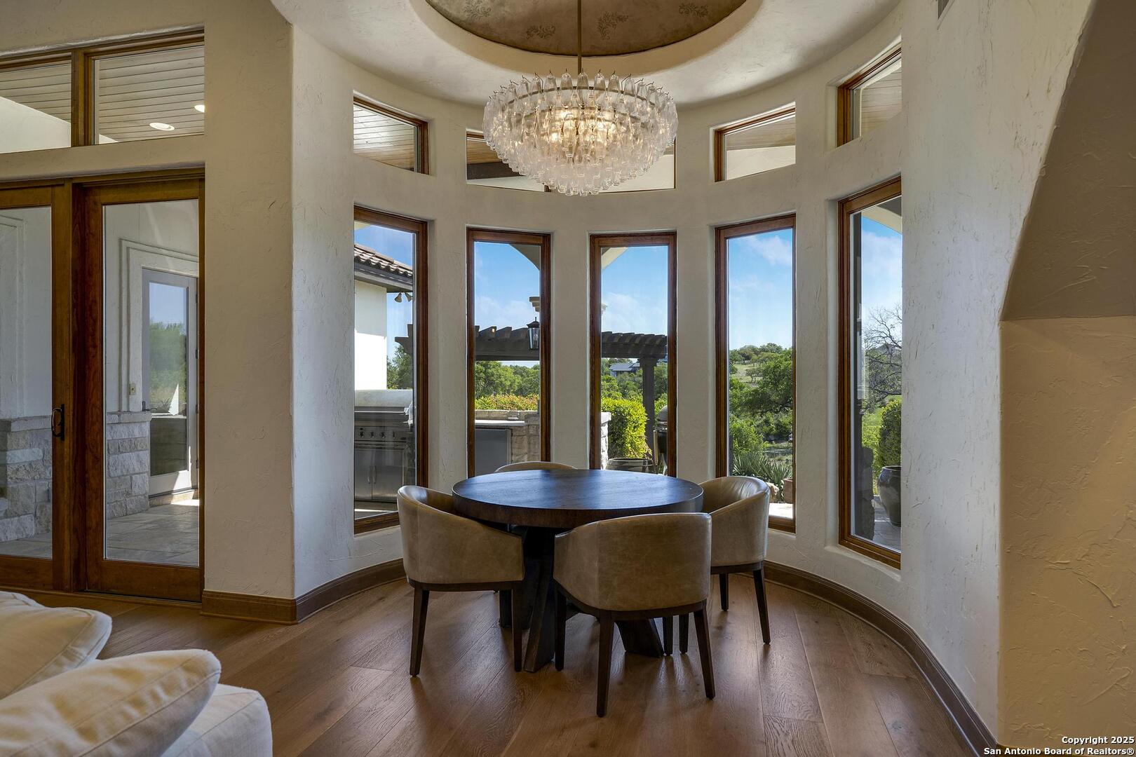 307 Augusta Boerne, TX 78006 - Photo 16 of 90 a dining room with furniture a chandelier and wooden floor