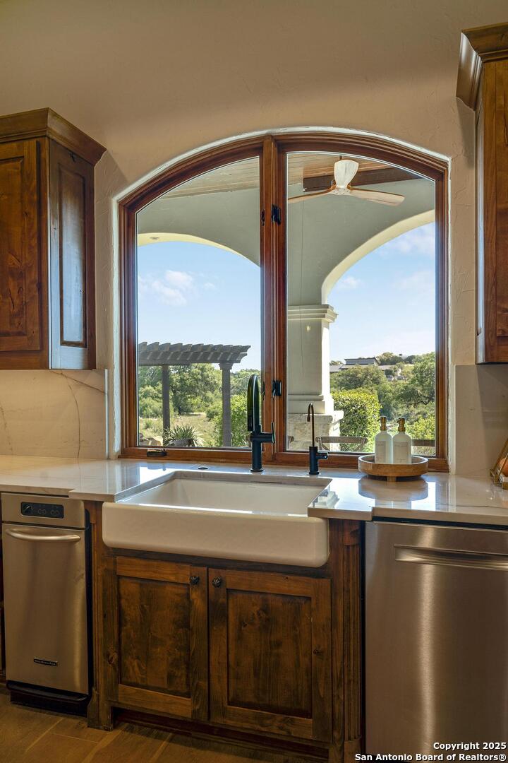 307 Augusta Boerne, TX 78006 - Photo 23 of 90 a kitchen with a large window sink and cabinets