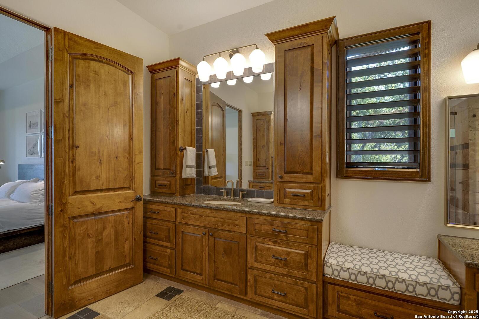 307 Augusta Boerne, TX 78006 - Photo 37 of 90 a bathroom with a sink a mirror and a shower