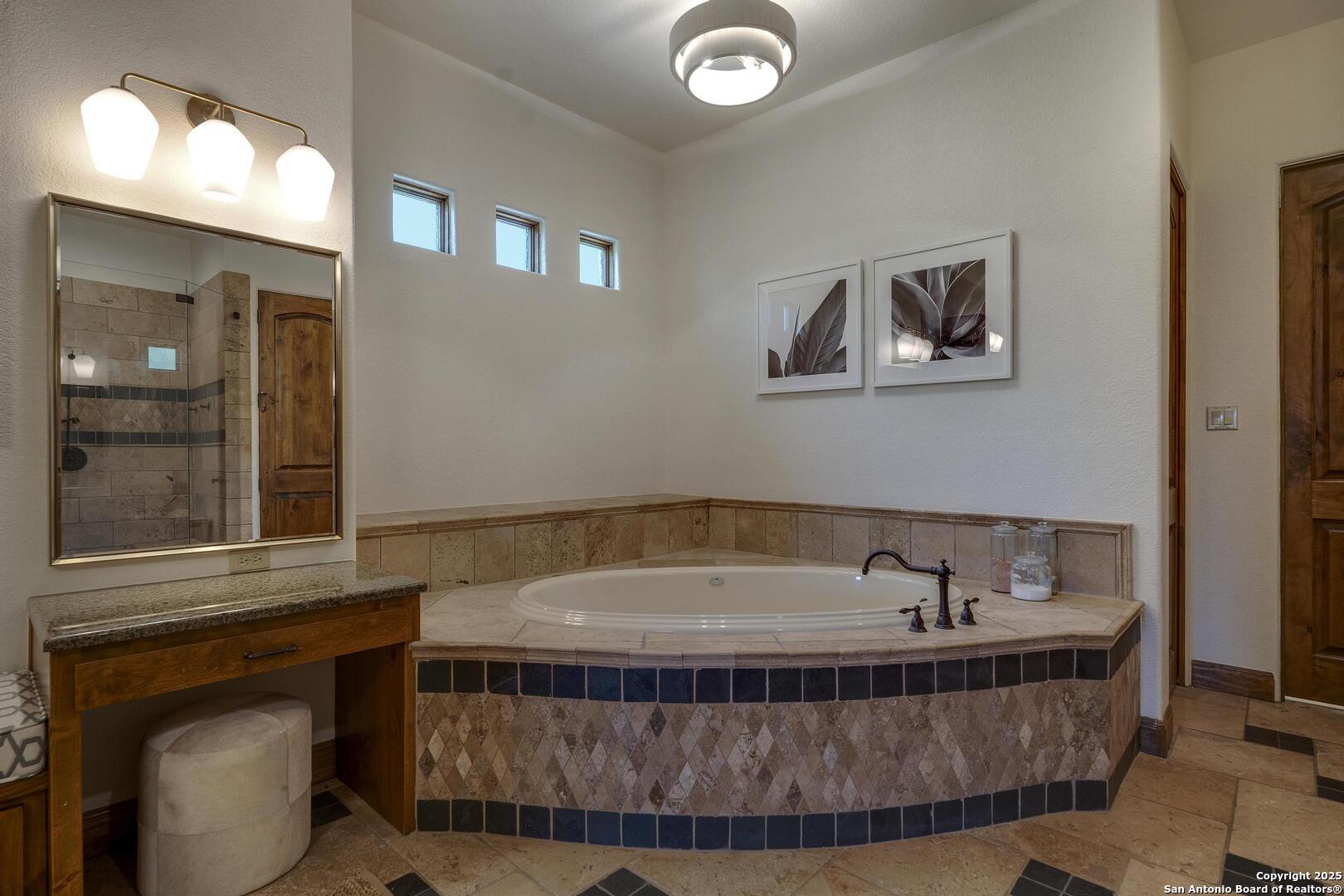 307 Augusta Boerne, TX 78006 - Photo 39 of 90 a bathroom with a tub and a mirror
