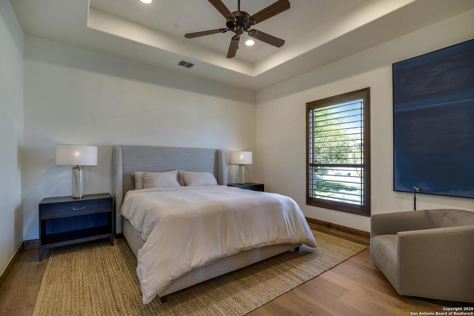 307 Augusta Boerne, TX 78006 - Photo 42 of 90 a bedroom with a bed and a chandelier