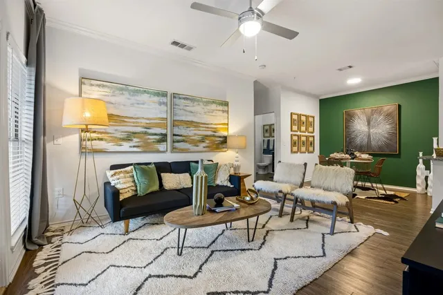 a living room with furniture and a floor to ceiling window