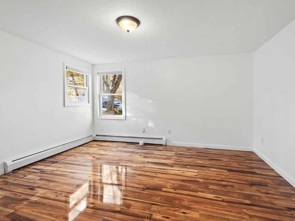 38 Hilda Street, Unit 1 Worcester, MA 01606 - Photo 13 of 38 a view of an empty room with window and wooden floor