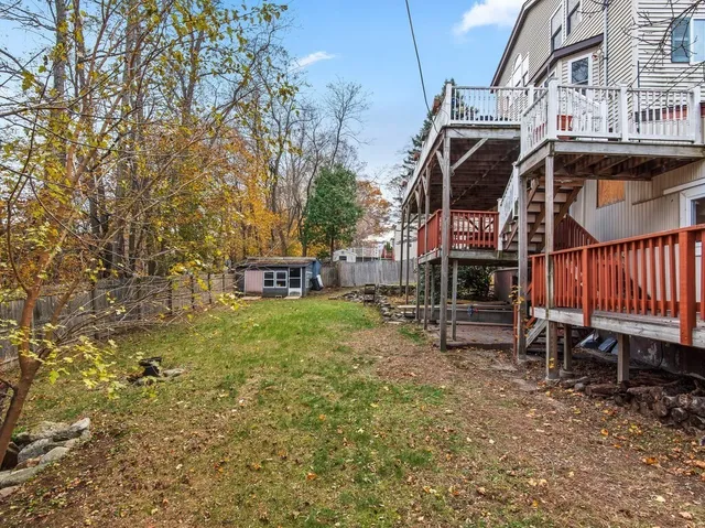 a view of a house with backyard and sitting area