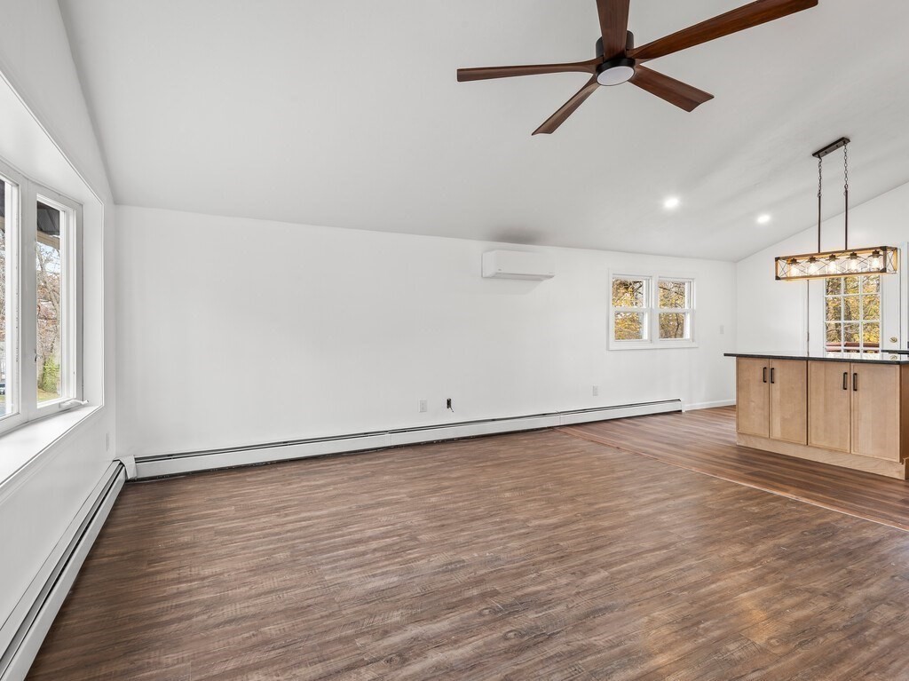 38 Hilda Street, Unit 1 Worcester, MA 01606 - Photo 3 of 38 an empty room with wooden floor fan and windows