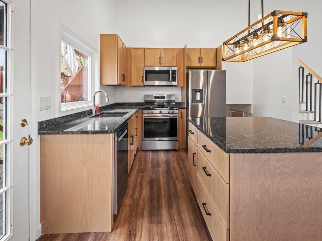 38 Hilda Street, Unit 1 Worcester, MA 01606 - Photo 7 of 38 a kitchen with granite countertop a sink a counter space stainless steel appliances and cabinets