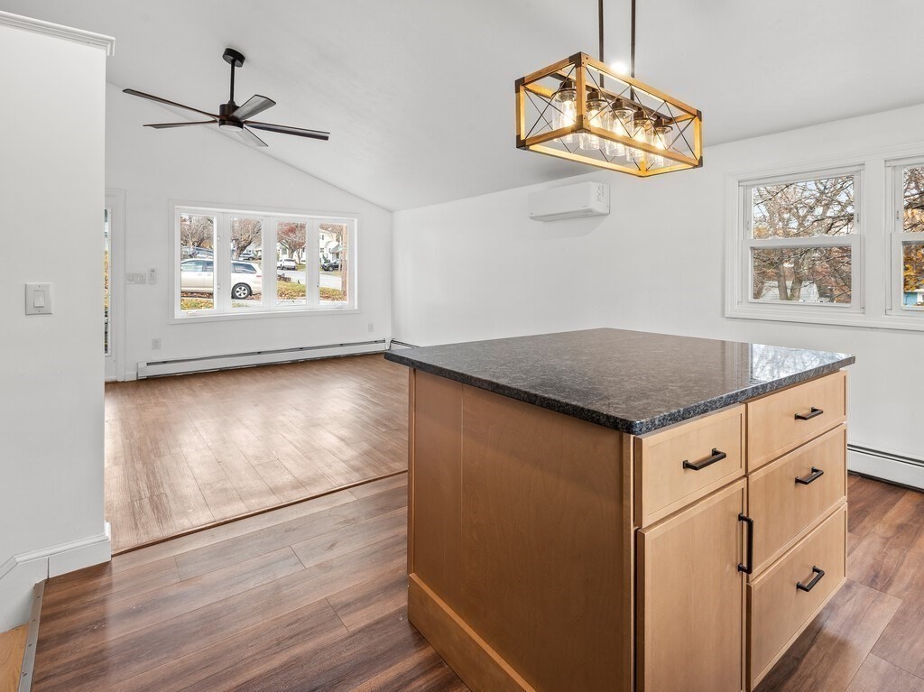 38 Hilda Street, Unit 1 Worcester, MA 01606 - Photo 9 of 38 a view of kitchen with granite countertop cabinets a window and a dining table