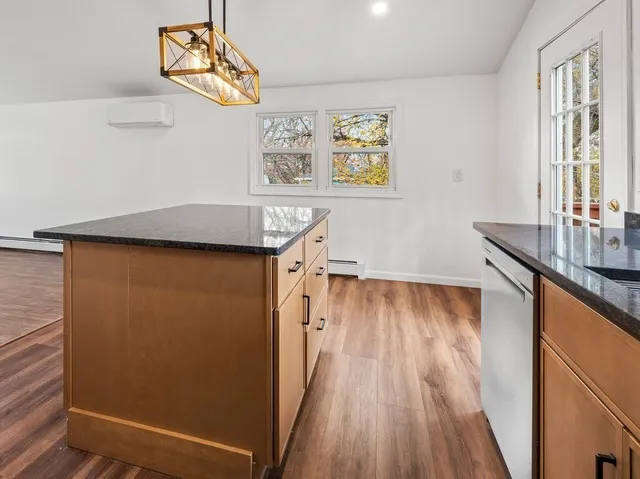 a hallway with a wooden floor and a sink