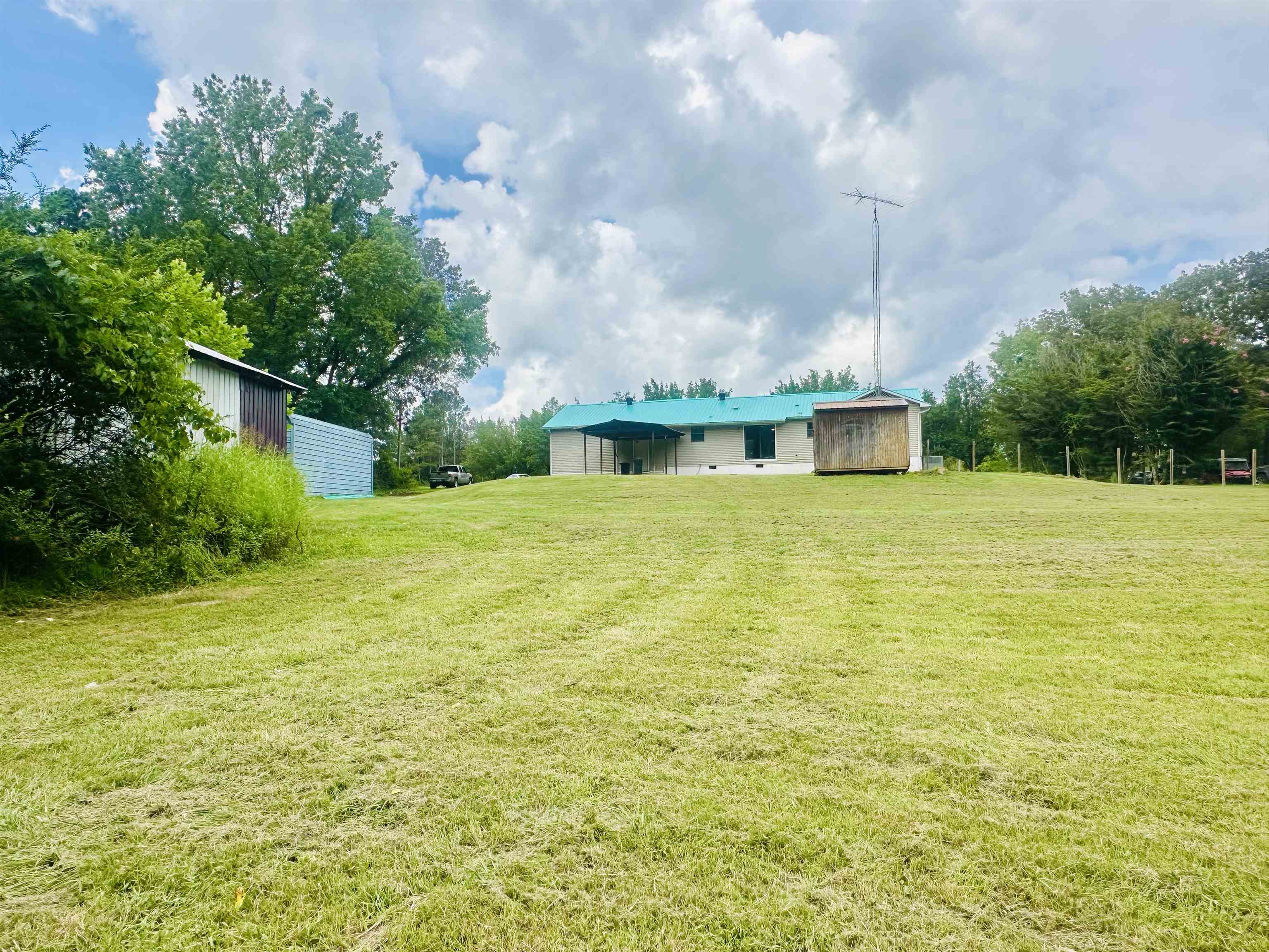287 Gilchrist Stantonville Road Adamsville, TN 38310 - Photo 15 of 29 View of green lawn featuring an outbuilding