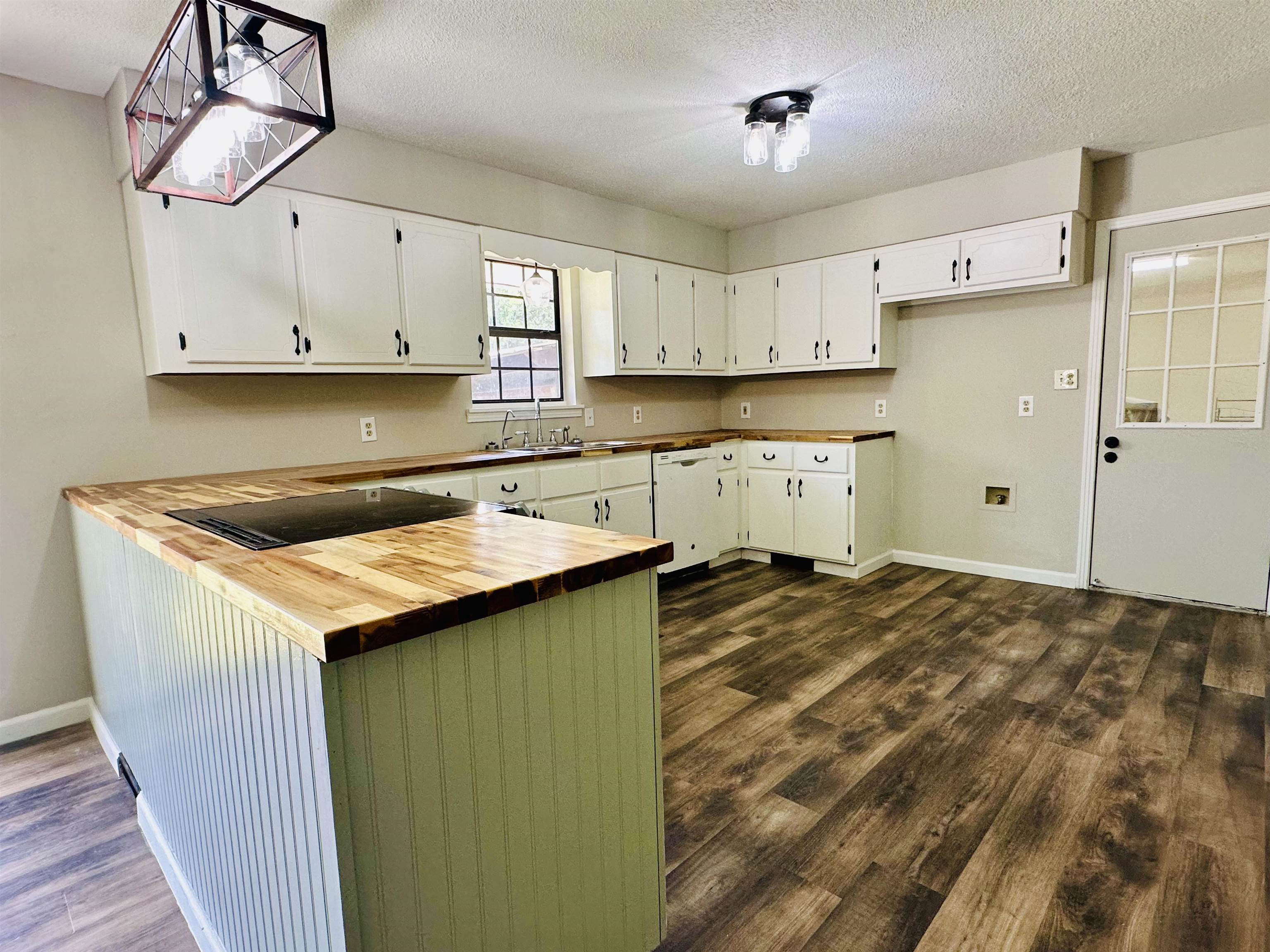 287 Gilchrist Stantonville Road Adamsville, TN 38310 - Photo 20 of 29 a kitchen with a stove a refrigerator and cabinets