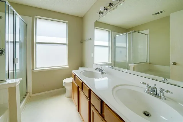 a bathroom with a sink double vanity and a bathtub