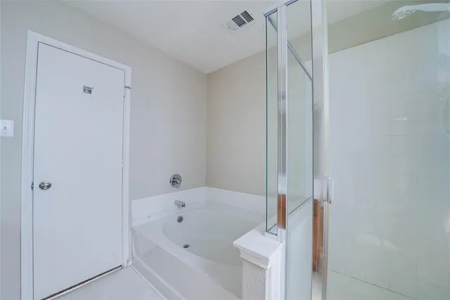 a bathroom with a bathtub and a shower