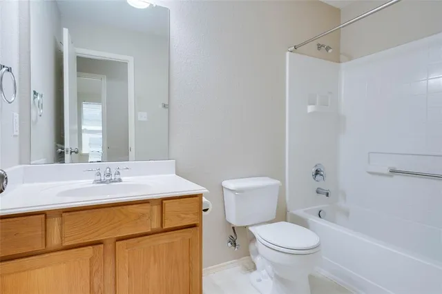 a bathroom with a sink toilet vanity and shower
