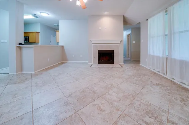 an empty room with a fireplace and cabinet
