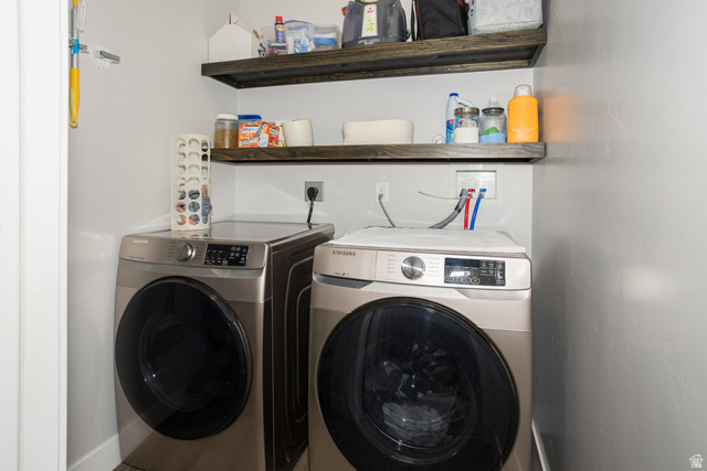 2452 West 500 South, Unit 2 Springville, UT 84663 - Photo 10 of 23 Dedicated laundry area featuring a front-loading washer and dryer, and built-in floating wood shelves for storage
