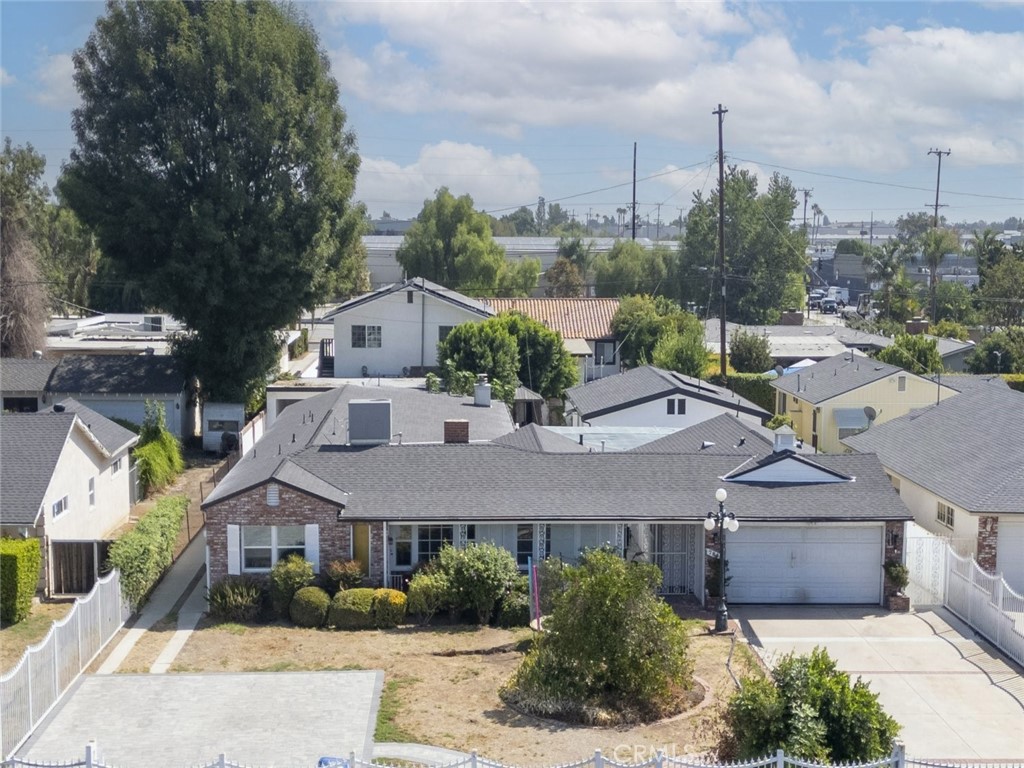 a aerial view of a house next to a yard