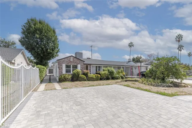 a front view of a house with a yard and table and chairs