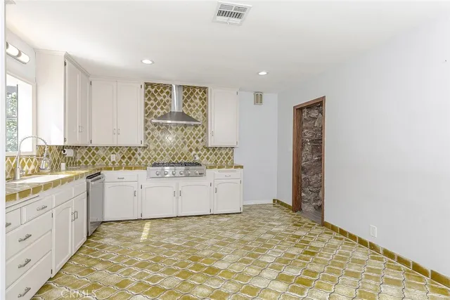 a kitchen with granite countertop a sink and cabinets