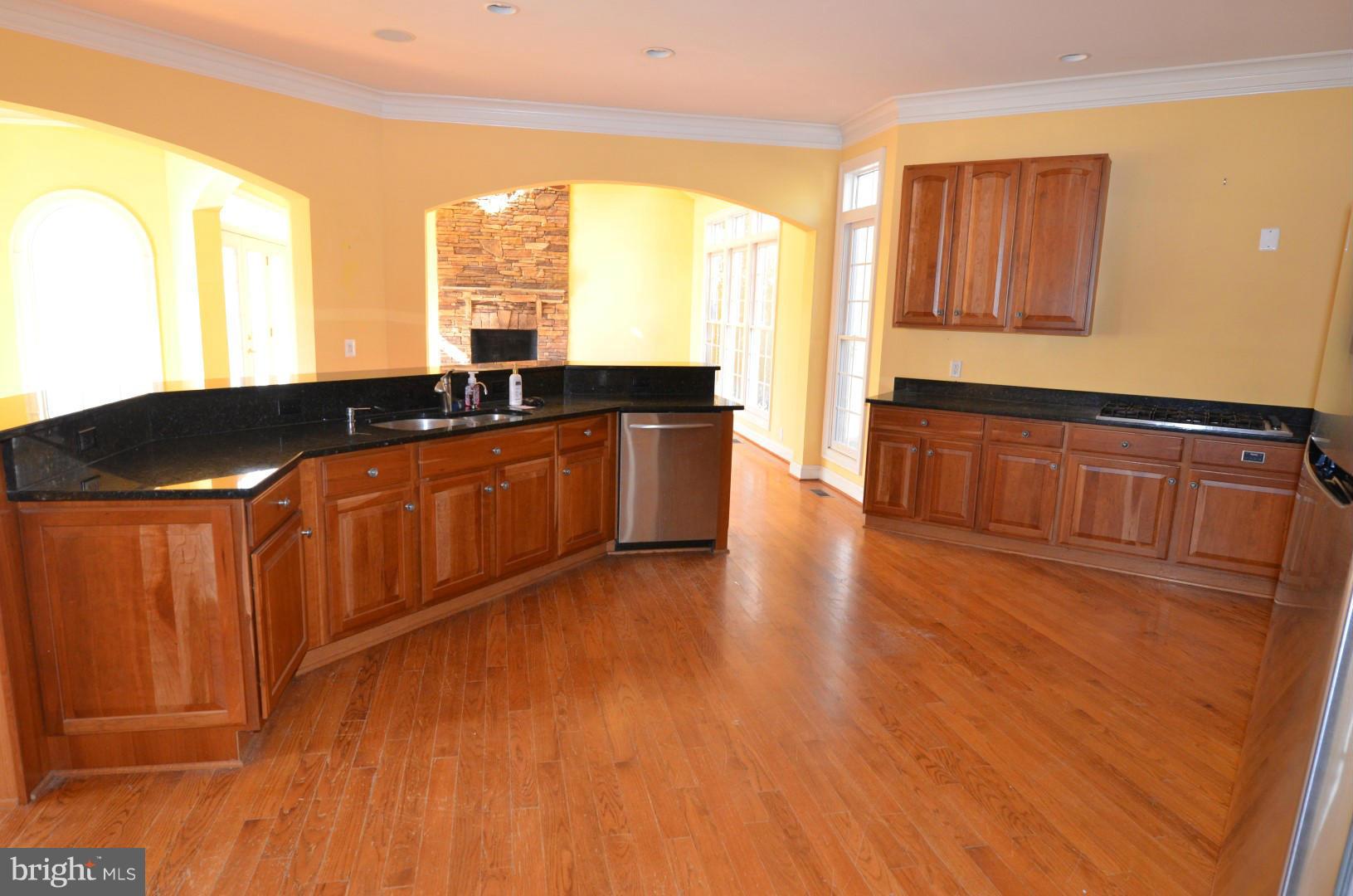 6434 Carters Run Road Marshall, VA 20115 - Photo 14 of 29 a kitchen with stainless steel appliances granite countertop wooden floors a stove and a microwave