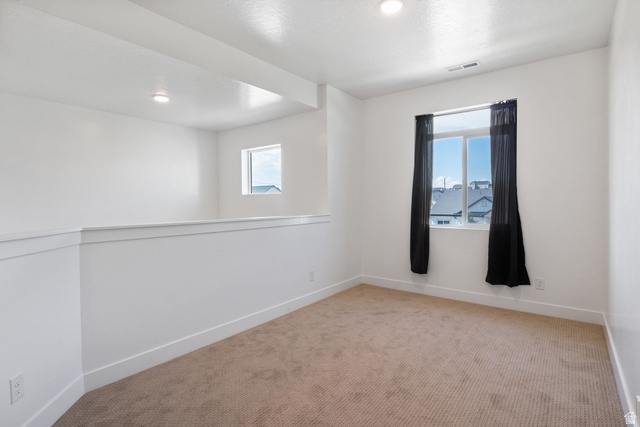 815 West Powderwood Lane Mapleton, UT 84664 - Photo 15 of 34 Carpeted room featuring white walls, recessed lighting, and a single window with dark curtains