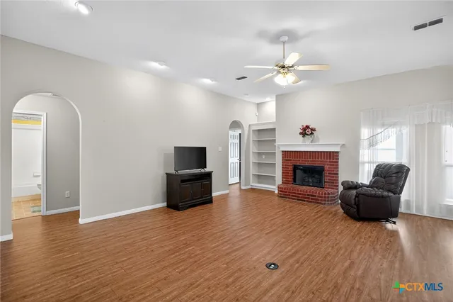 a living room with furniture a fireplace and a flat screen tv