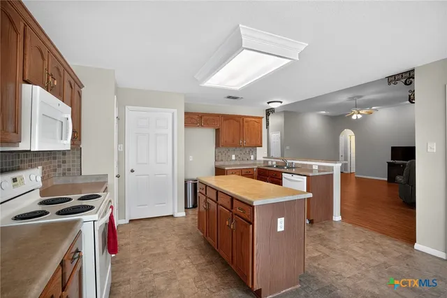 a large kitchen with a stove and a sink