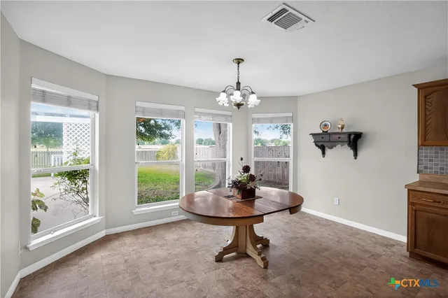 a view of a room with a table and chairs