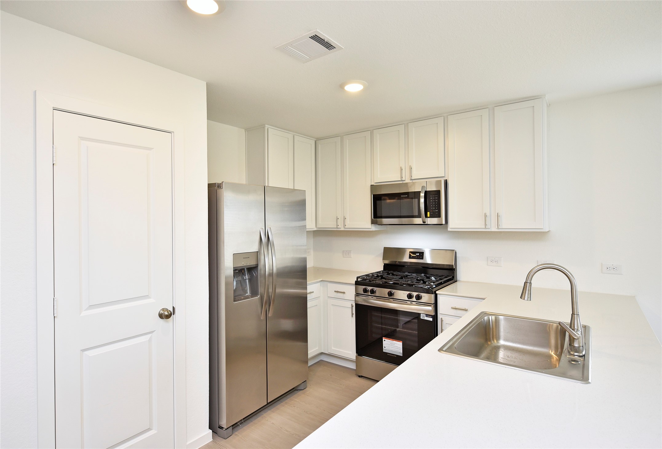 10218 Prairie Dunes Lane Cleveland, TX 77327 - Photo 12 of 32 a kitchen with a refrigerator stove and microwave