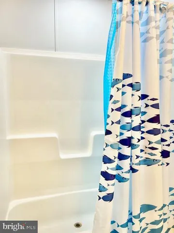 a bathroom with a bathtub and shower