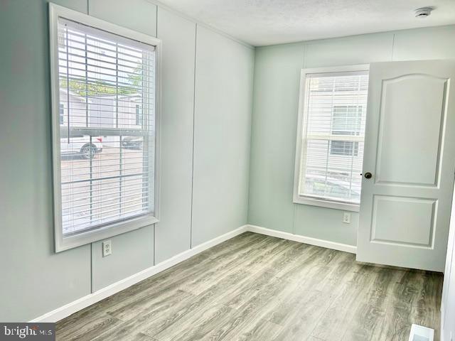 26 2nd Street Lothian, MD 20711 - Photo 15 of 27 a view of empty room with wooden floor and fan