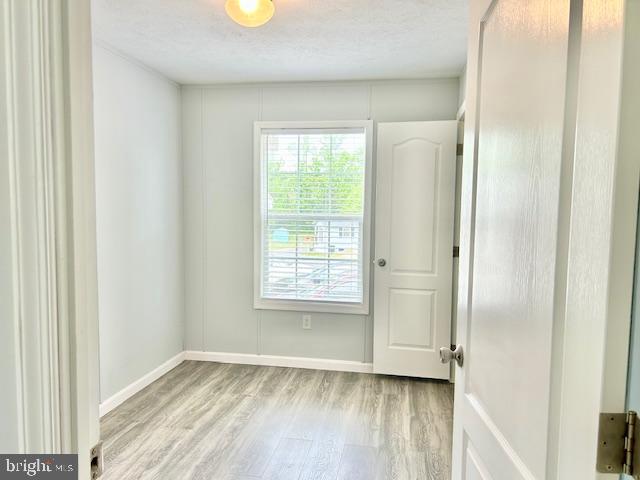 26 2nd Street Lothian, MD 20711 - Photo 16 of 27 a view of an empty room with wooden floor and a window