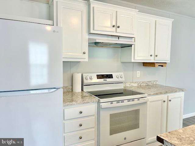 26 2nd Street Lothian, MD 20711 - Photo 4 of 27 a kitchen with granite countertop white cabinets and white appliances