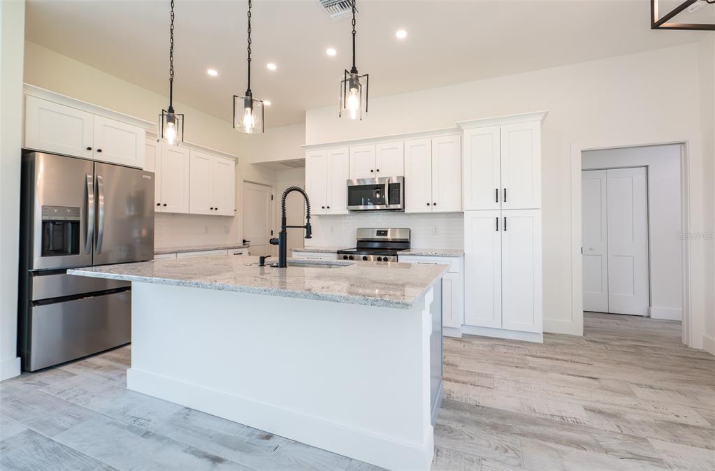 8846 Southwest Liverpool Road Arcadia, FL 34269 - Photo 8 of 29 a kitchen with kitchen island a sink stainless steel appliances and cabinets