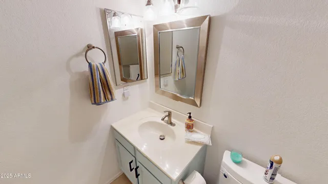 a bathroom with a sink vanity and a mirror