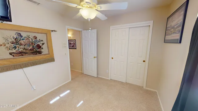 a view of a hallway with a chandelier fan