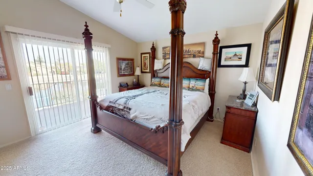 a bed sitting in a bedroom next to a window
