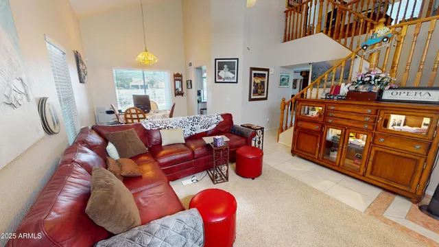 a living room with furniture a fireplace and a chandelier