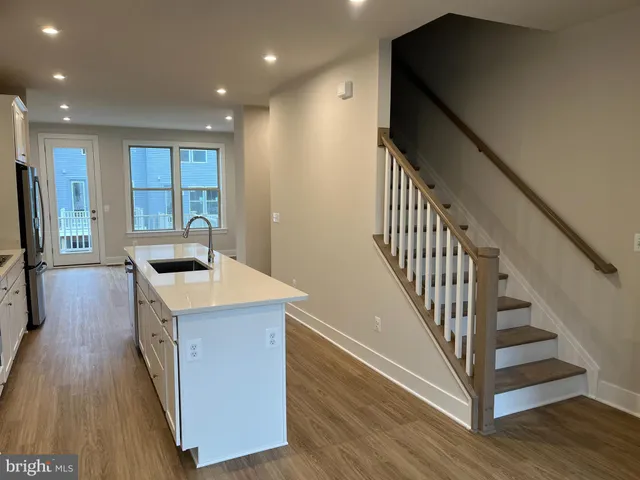 a kitchen with granite countertop a sink and a refrigerator