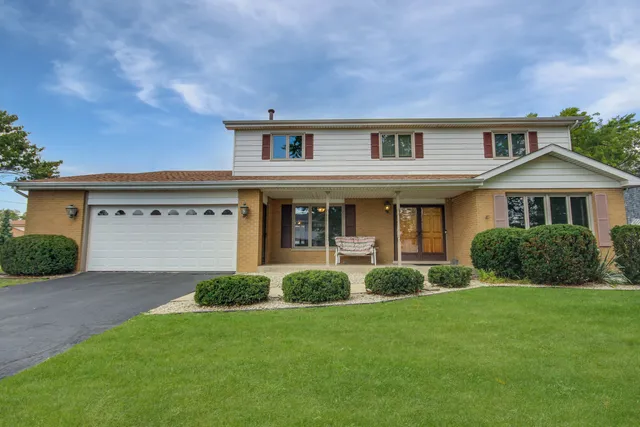 a front view of a house with a yard and porch