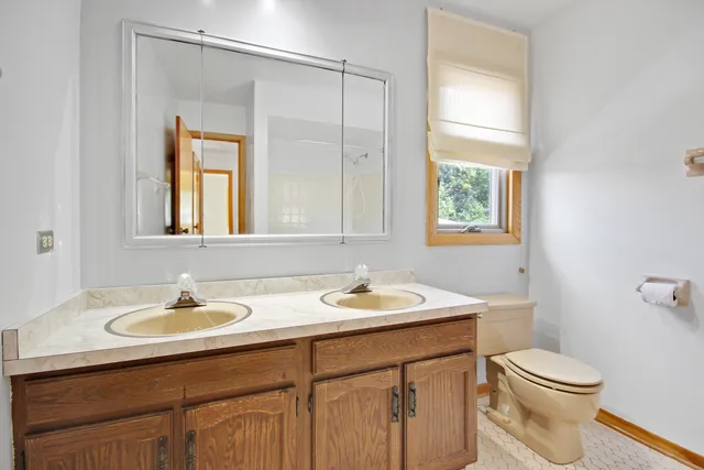 a bathroom with a sink toilet and a mirror