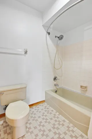 a bathroom with a toilet and a bath tub