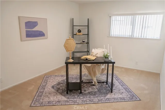 a view of a workspace room with furniture