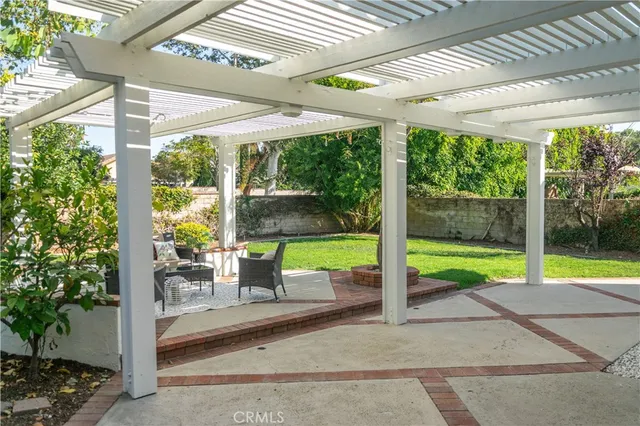 a view of a porch with furniture and garden