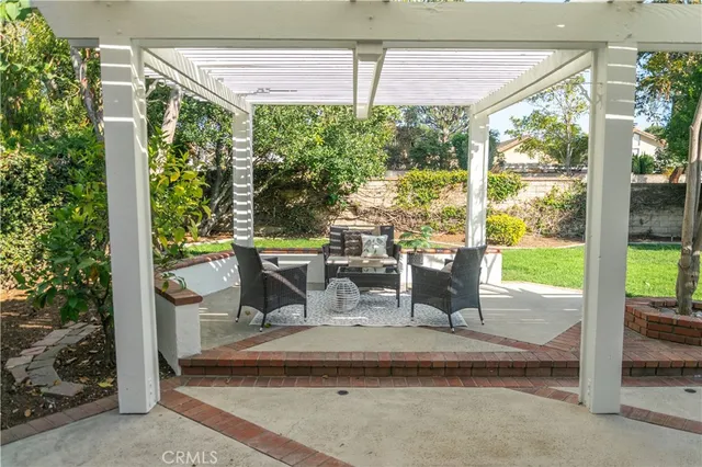 a view of a porch with chairs and backyard