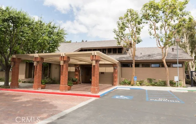 a view of a white house with a large windows and a large tree with large windows